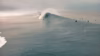 Surfer riding a large powerful ocean wave